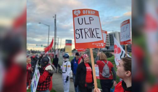 Photo of striking OFNHP workers. Sign reads "OFNHP - ULP Strike"
