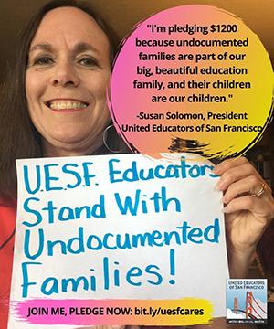 woman holds sign that supports standing with undocumented families