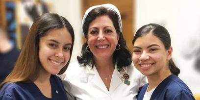 Photo of Linda Romano and two students in Newburgh, N.Y.