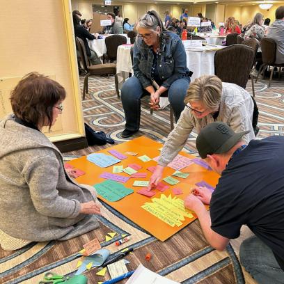 Members of the Oregon School Employees Association, Reynolds chapter, make a three-sided poster laying out their vision, goals and plans.
