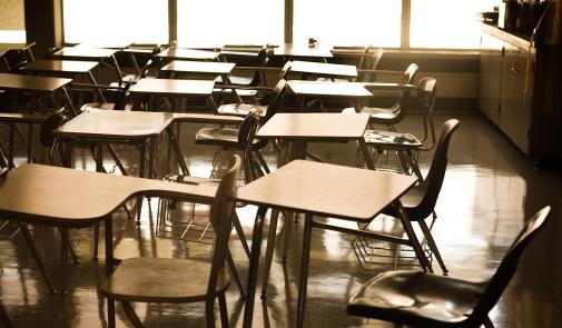 empty classroom shows empty desks all facing the left