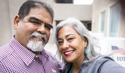 Latino couple voting