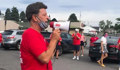 man yelling into bull horn