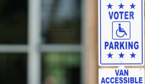 Photo showing a sign indicating reserved parking for voters with disabilities