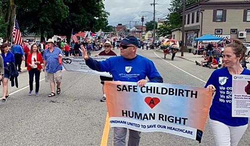 people walk with sign that says safe childbirth a human right
