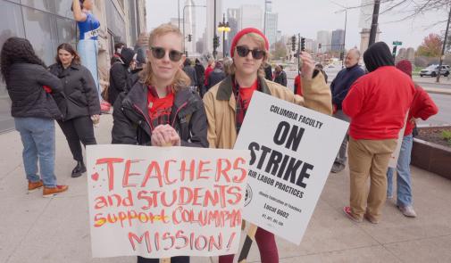 students on strike hold signs in support of the strike