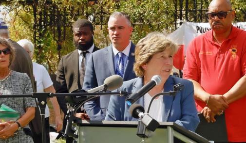 Photo of Randi Weingarten speaking at rally, surrounded by union officials