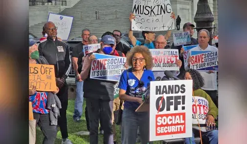 Brenda Marks and other protestors hold signs in group picture