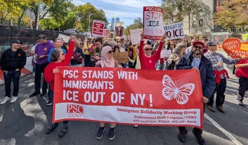 Marchers holding Stands With Immigrants banner