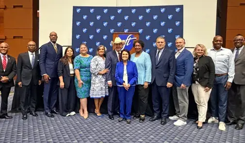 A large group of people pose together for a photo at the Human Rights Luncheon. 