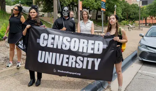 Protesters holding banner that reads Censored University