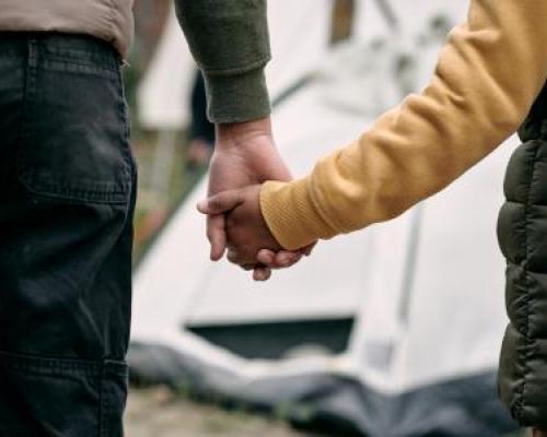 Photo of two people holding hands