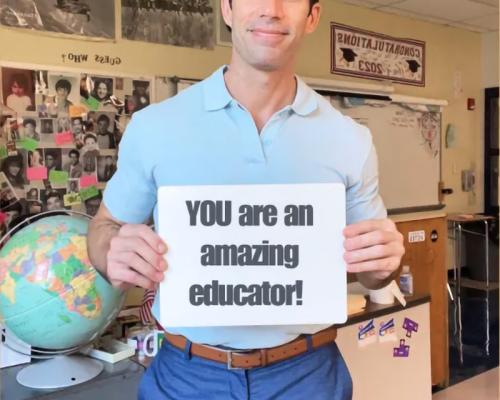 Teacher holding a sign that says "YOU are an amazing educator!"