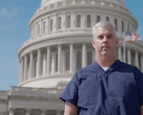 Photo of Dr. Byrce Pulliam in front of the U.S. Capitol building