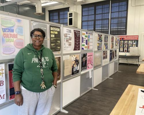 Letecia Miller with student work in her graphic design classroom
