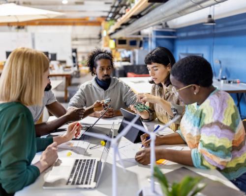 Tech workers collaborating. Photo credit: gettyimages.com/alvarez