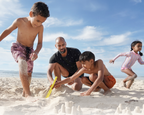 Family playing on the beach