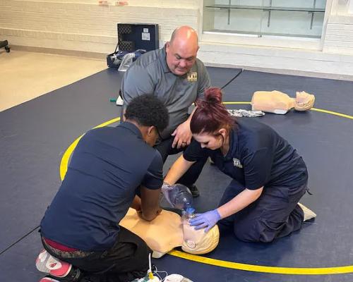Pittsburgh Federation of Teachers member Matthew Patrick instructs students on CPR/AED as part of an EMT class in the Westinghouse Emergency Response Technology program in Pittsburgh