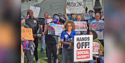 Brenda Marks and other protestors hold signs in group picture