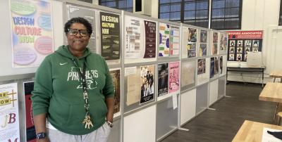 Letecia Miller with student work in her graphic design classroom