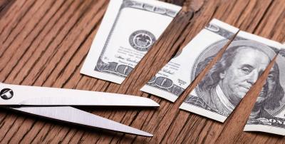 scissors and a cut up hundred dollar bill
