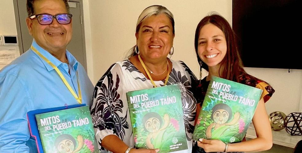 Author Evelyn Taino posing with two adult readers, all holding copies of her book