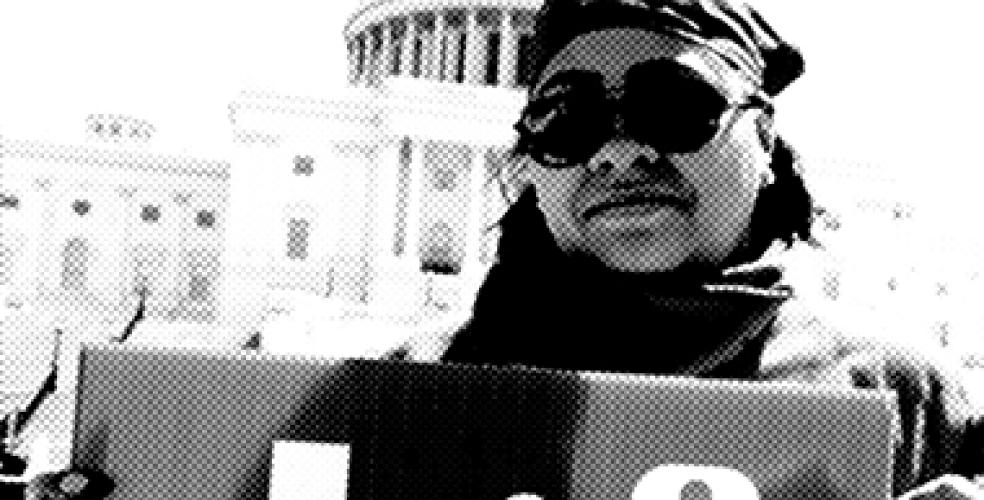 a woman holds a sign