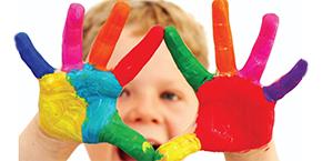 Igniting the fire. Photo shows child with paint covered palms