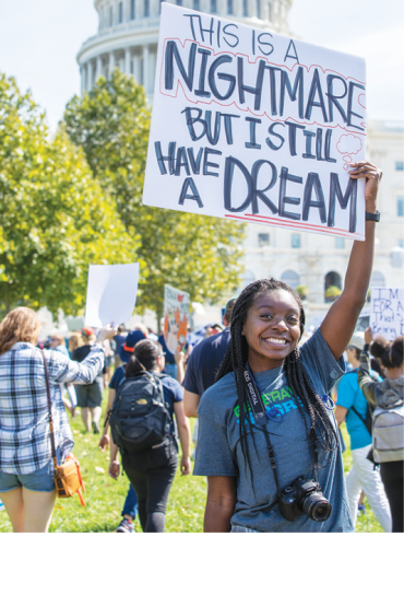 global climate strike, girl holding sign that reads this is a nightmare but I still have a dream 