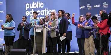 women stand on stage