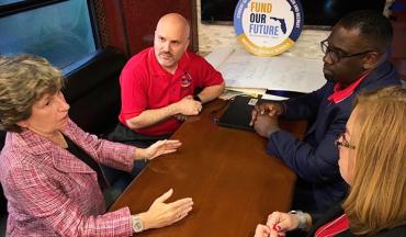 From left, AFT President Randi Weingarten joins FEA leaders Andrew Spar, Fedrick Ingram and Carole Gauronskas in Dade County during the Fund Our Future bus tour.