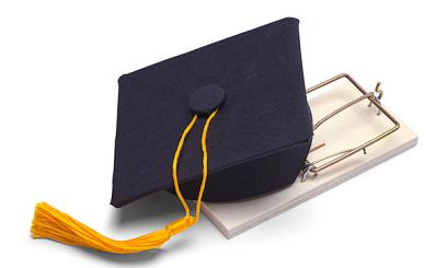 a graduation cap sits on top of a mousetrap