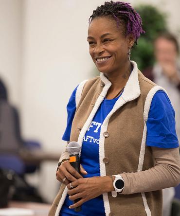 Woman at microphone AFT Votes