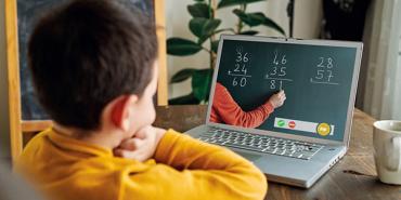 child viewing a lesson on a laptop computer