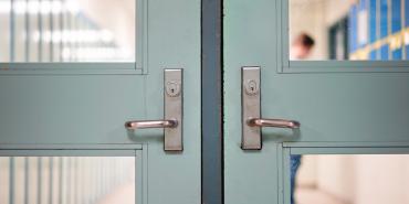 a picture of a set of pale green doors, of of which have silver handles and two windows