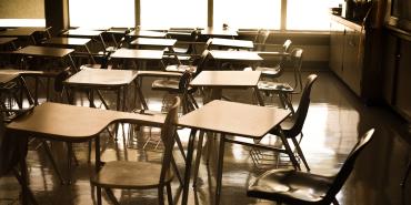 empty classroom shows empty desks all facing the left