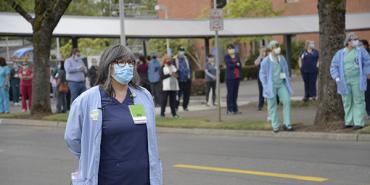 Female nurse from ONA Hillsboro stands with other health staff in the background