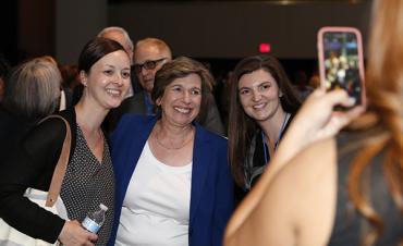 Posing with members after the speech