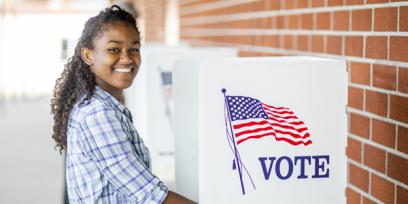 young black woman votes