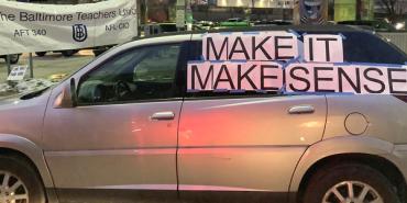 car that says make it make sense on the window