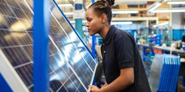 Woman looking at solar panel