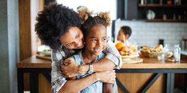 mom hugging daughter