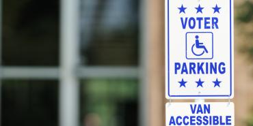 Photo showing a sign indicating reserved parking for voters with disabilities