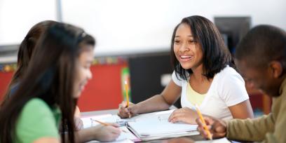 a group of multiracial students engage in a group assignment