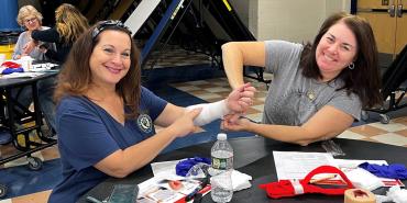 Photo of AFT members at training. From left, Laura Davis and Kristine Flory, who also took the AVERT training in Williamstown, N.J.