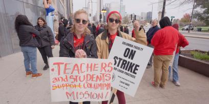 students on strike hold signs in support of the strike