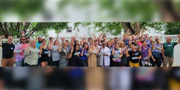 Photo of United Faculty of ISU members standing together, smiling with raised fists