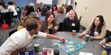 JEDI participants play Finish Line, a board game where they adopt different student identities to understand student challenges on campus. Photo courtesy of FASCC.