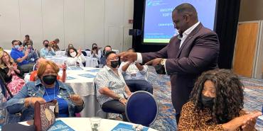 AFT Secretary-Treasurer Fedrick Ingram (standing right) and AFT Secretary-Treasurer Emeritus Lorretta Johnson (front left).