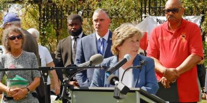 Photo of Randi Weingarten speaking at rally, surrounded by union officials